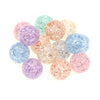 A collection of round glitter acrylic beads in various shades including purple, pink, blue, and gold.