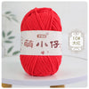 A ball of bright red chenille yarn labeled with Chinese characters for knitting and crochet.