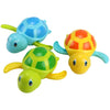 A set of colorful wind-up swimming turtle bath toys in blue, yellow, and green.