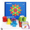 A box of 155-piece wooden pattern blocks with colorful geometric designs and design cards displayed on a white cloth.