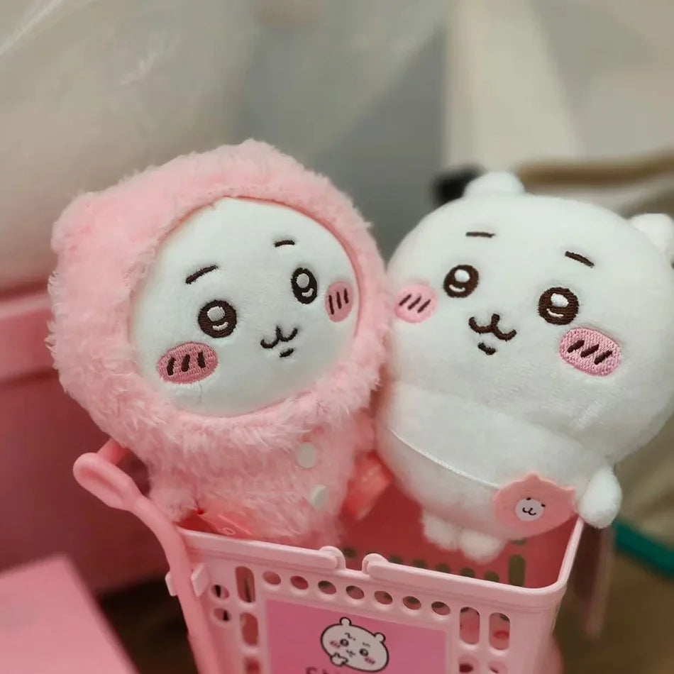 A pink Usagi Hachiware plush keychain in a pajama theme is shown inside a pink basket.