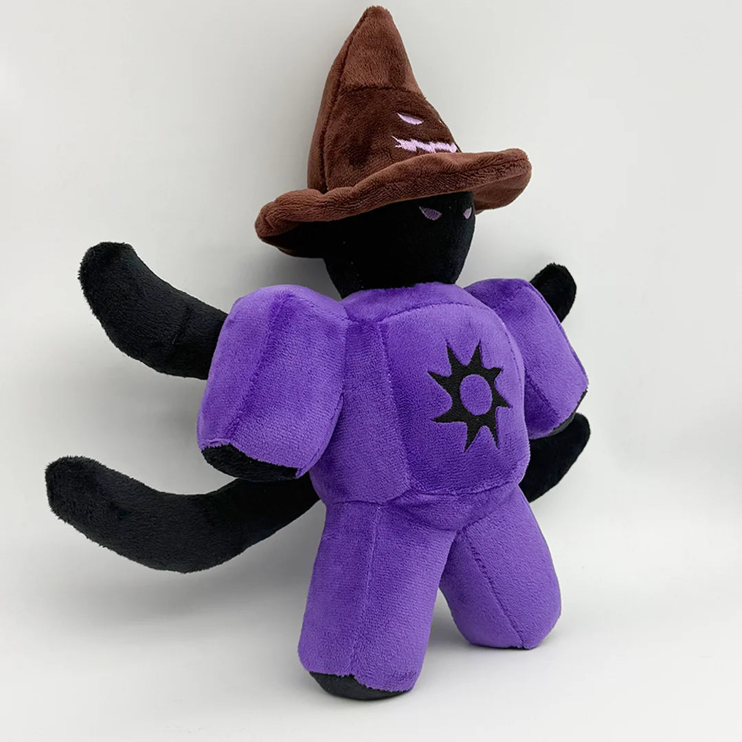 A black plush toy with a brown witch hat and purple body featuring a star design on the chest.