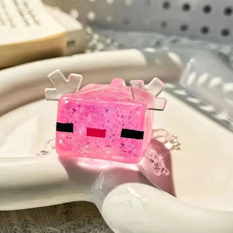 A pink strawberry crunchy squishy stress relief toy with black eyes and white hair resting on a white dish.