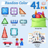 A collection of magnetic building blocks, including geometric shapes, a storage bag, and an idea book.
