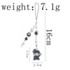 A silver anime-inspired keychain featuring a charm and a hanging loop.