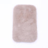 A rectangular, light beige faux fur mat designed for dollhouse decor.