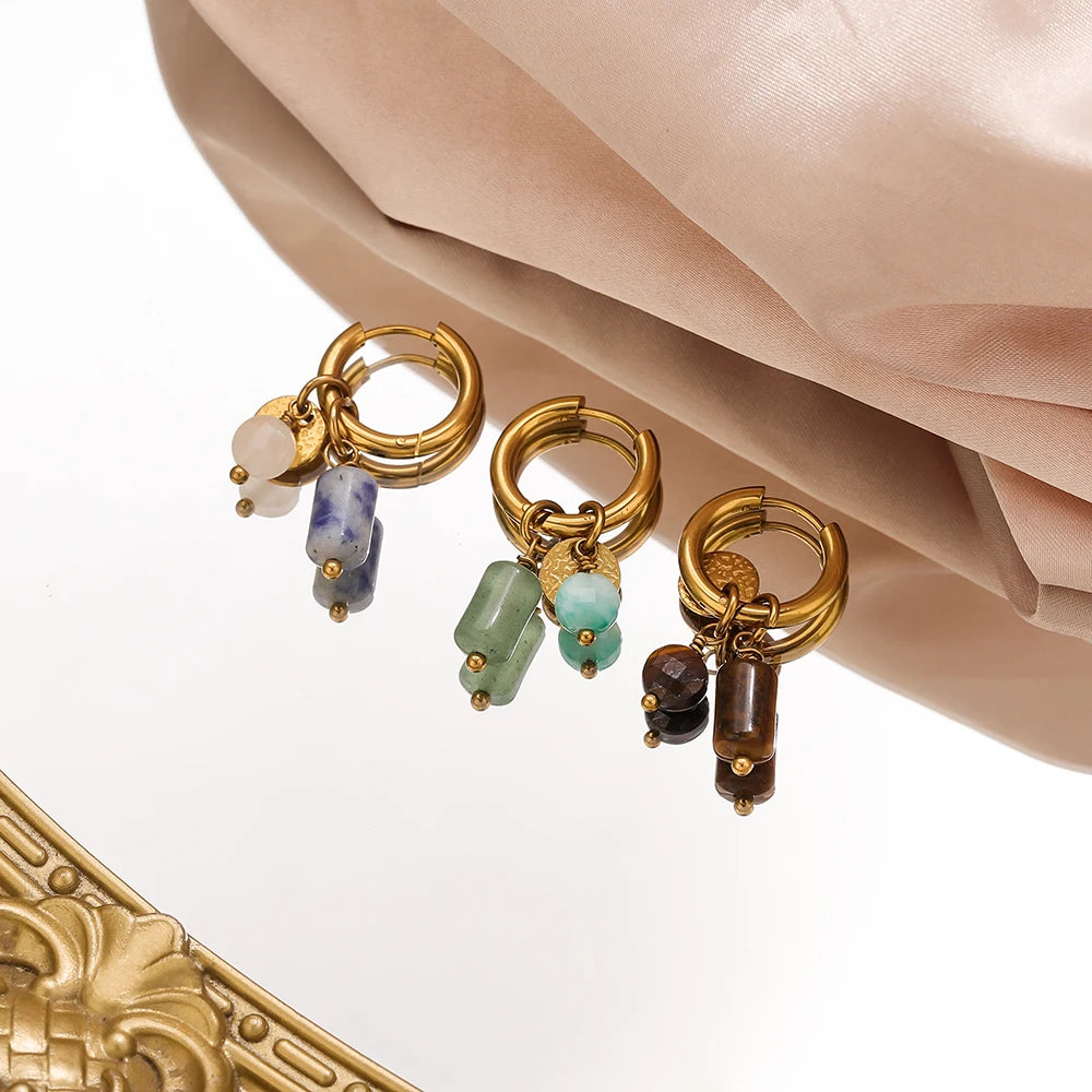 Gold hoop earrings featuring various natural stones including blue and green gems