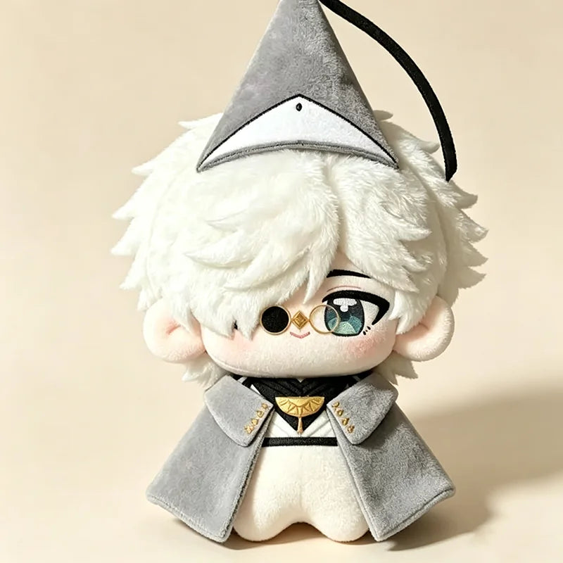 A white plush doll with light gray hair wearing a witch hat and a gray coat.