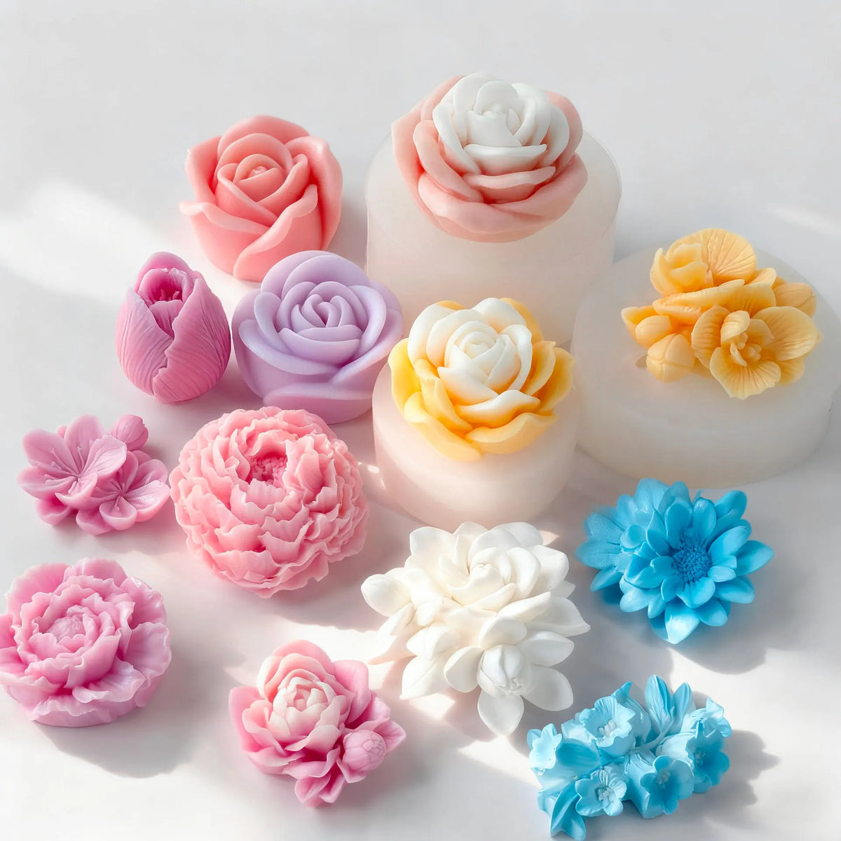 A collection of multi-flower silicone molds in shades of pink, peach, lavender, and white for crafting.