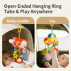 A baby is shown playing with a crab-themed rattle and teether toy hanging from a strap in a stroller or car seat.