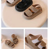 A set of tan and black soft-soled sandals displayed from overhead, side, toe, and heel angles.