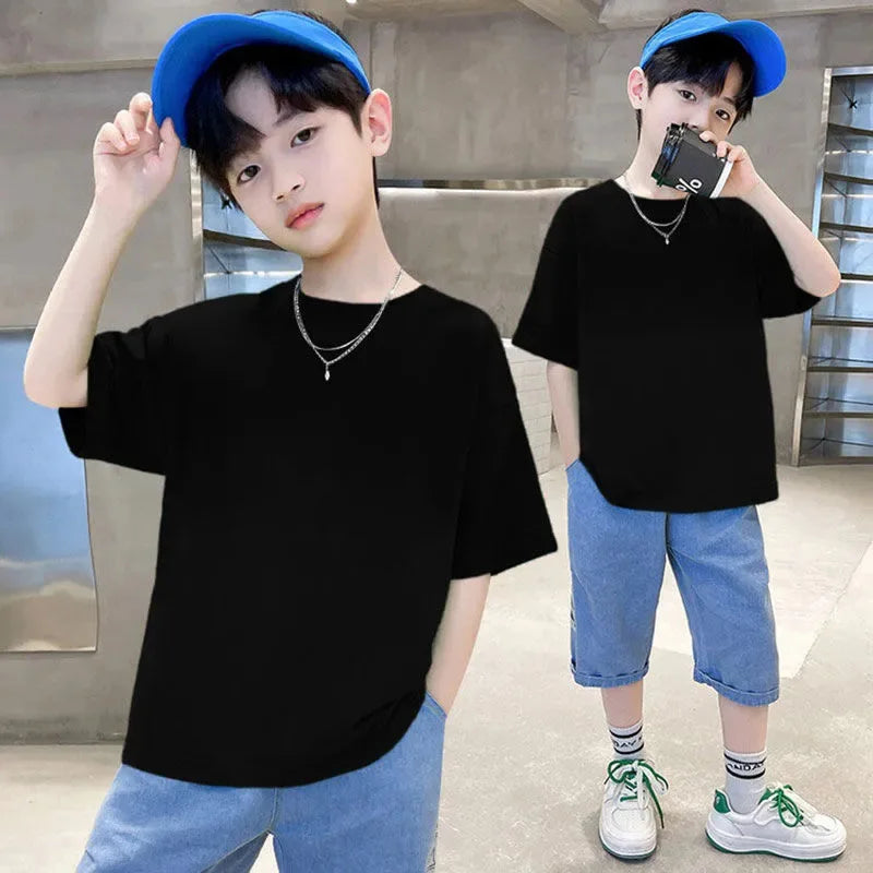 A young male model wearing a black classic cotton crew neck t-shirt and blue baseball cap standing indoors.
