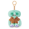 A light green plush monster with large eyes and brown clothing attached to a gold-colored keychain ring.