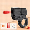 A black mini shell-ejecting fidget pistol is shown with red pellets and a blue string on a light background.