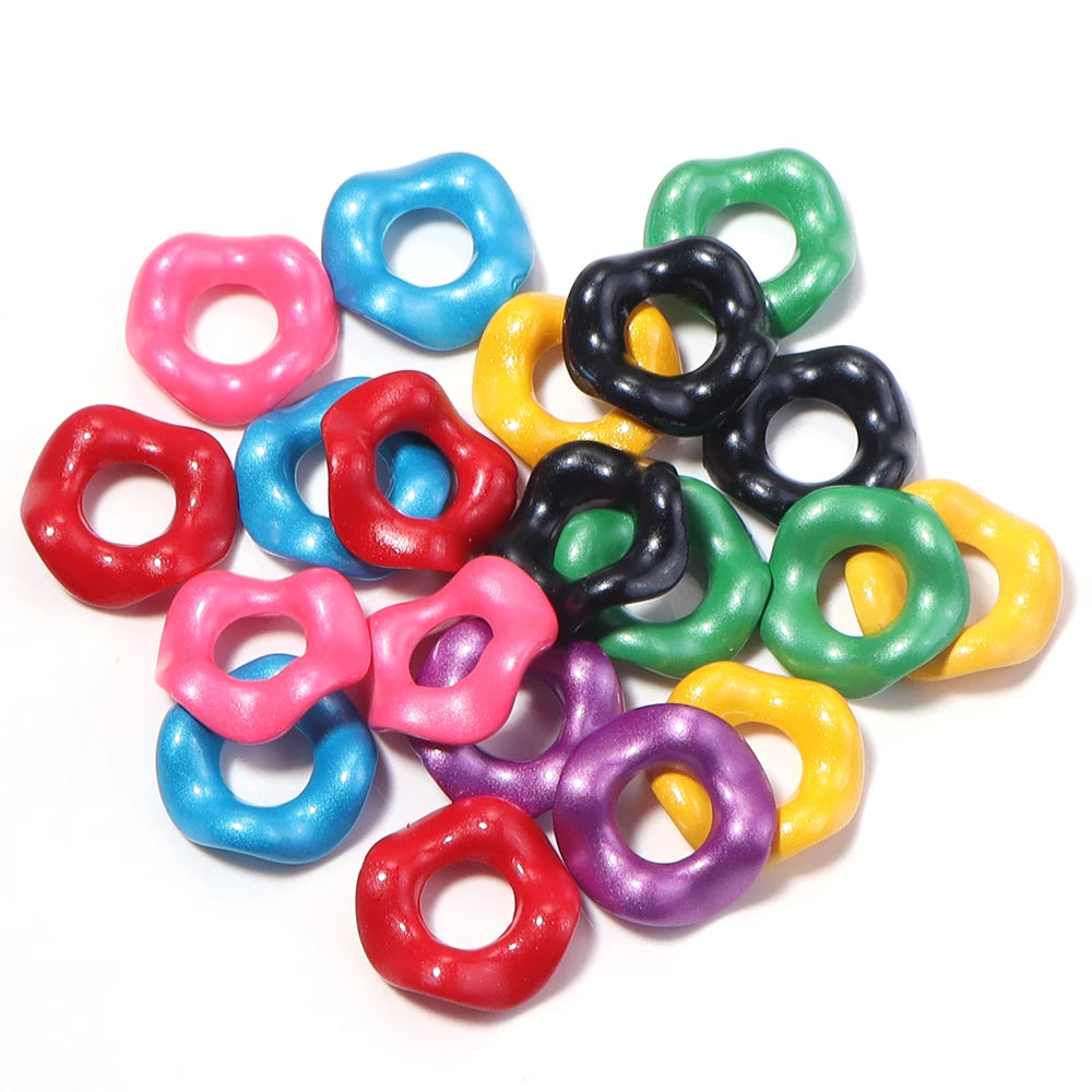 Assortment of colorful acrylic spacer beads in various shades including pink, blue, green, and yellow.