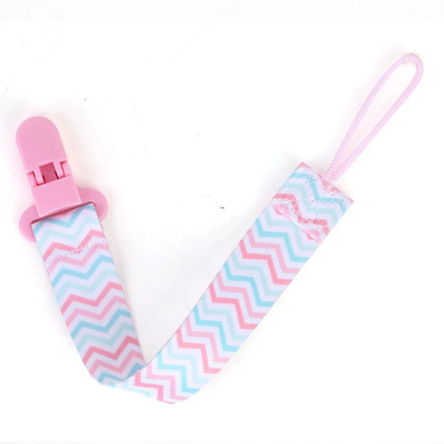 Pink pacifier clips with double-sided prints featuring a chevron pattern for babies
