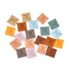 A collection of twenty colorful embossed leather labels for sewing and crafts arranged in a circular pattern.
