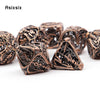 A set of coppery skull metal polyhedral dice for tabletop games, showing various shapes and engravings.