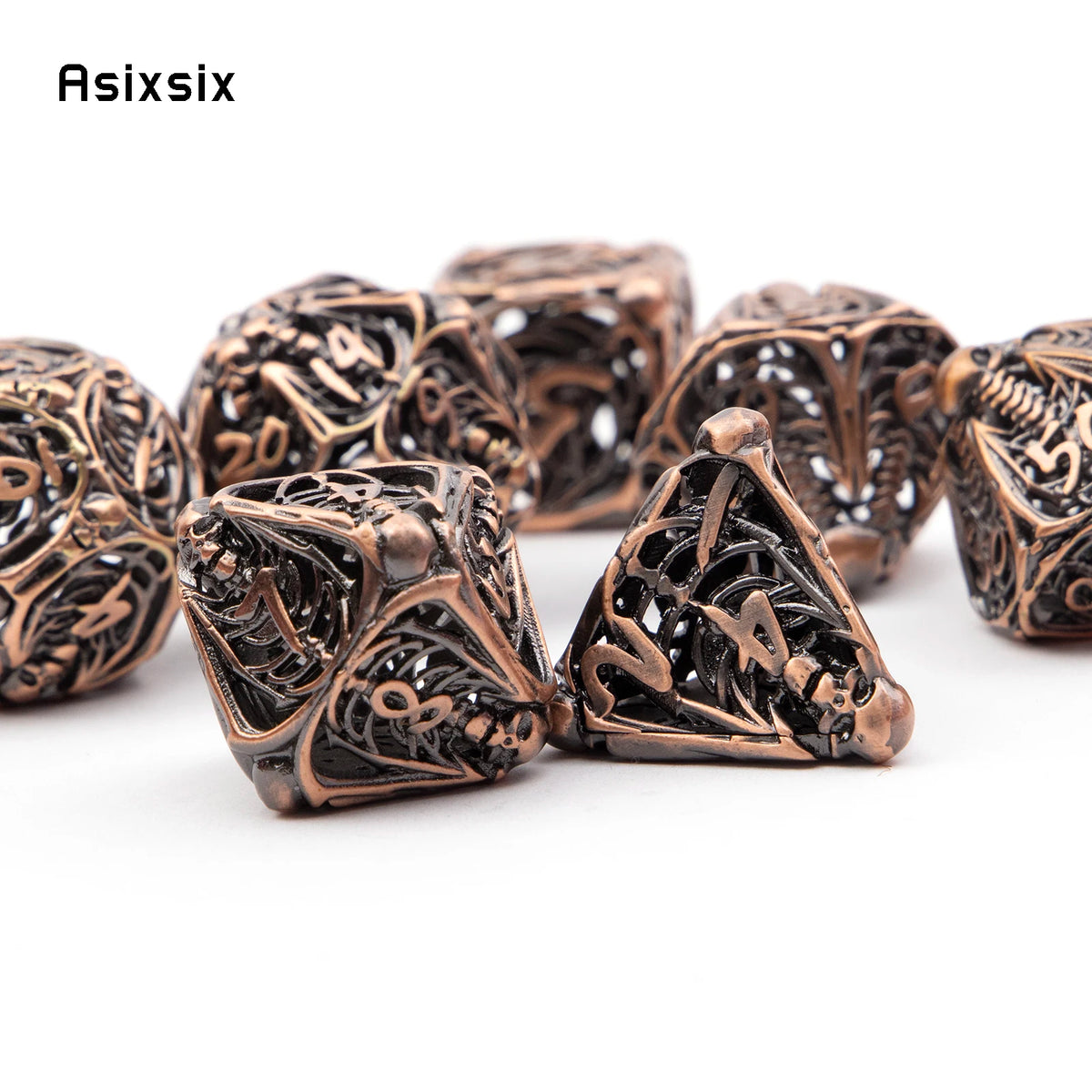 A set of coppery skull metal polyhedral dice for tabletop games, showing various shapes and engravings.