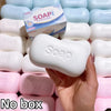 A hand holds a white soap ball squishy fidget toy next to various colored soap balls and a box.