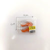 A clear plastic package containing realistic salmon and steak food rolls.