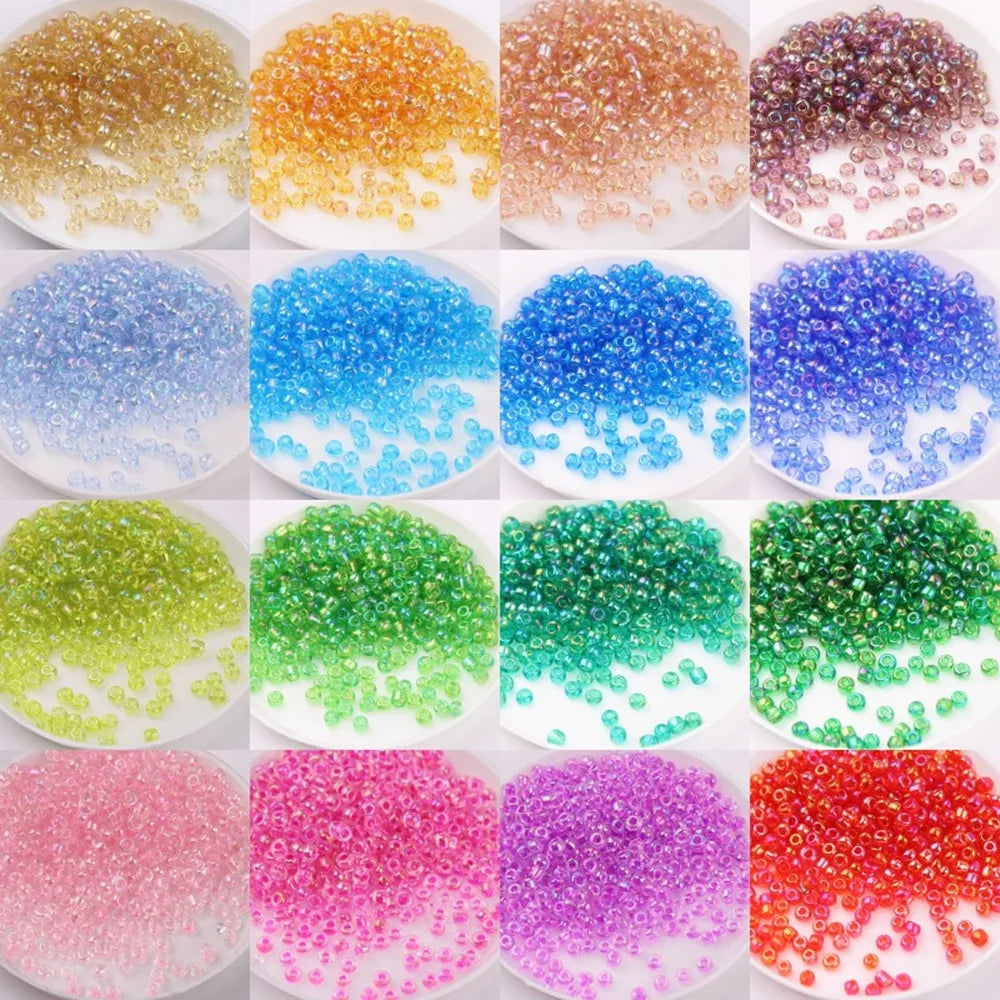 A collection of brightly colored glass rice beads in various shades including yellow, orange, blue, green, pink, and purple.