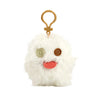 A white fluffy plush monster with large brown eyes and a pink tongue attached to a gold keychain ring.