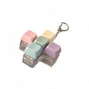 A set of five pastel-colored clicking keyboard fidget toys with a metal keychain attached.