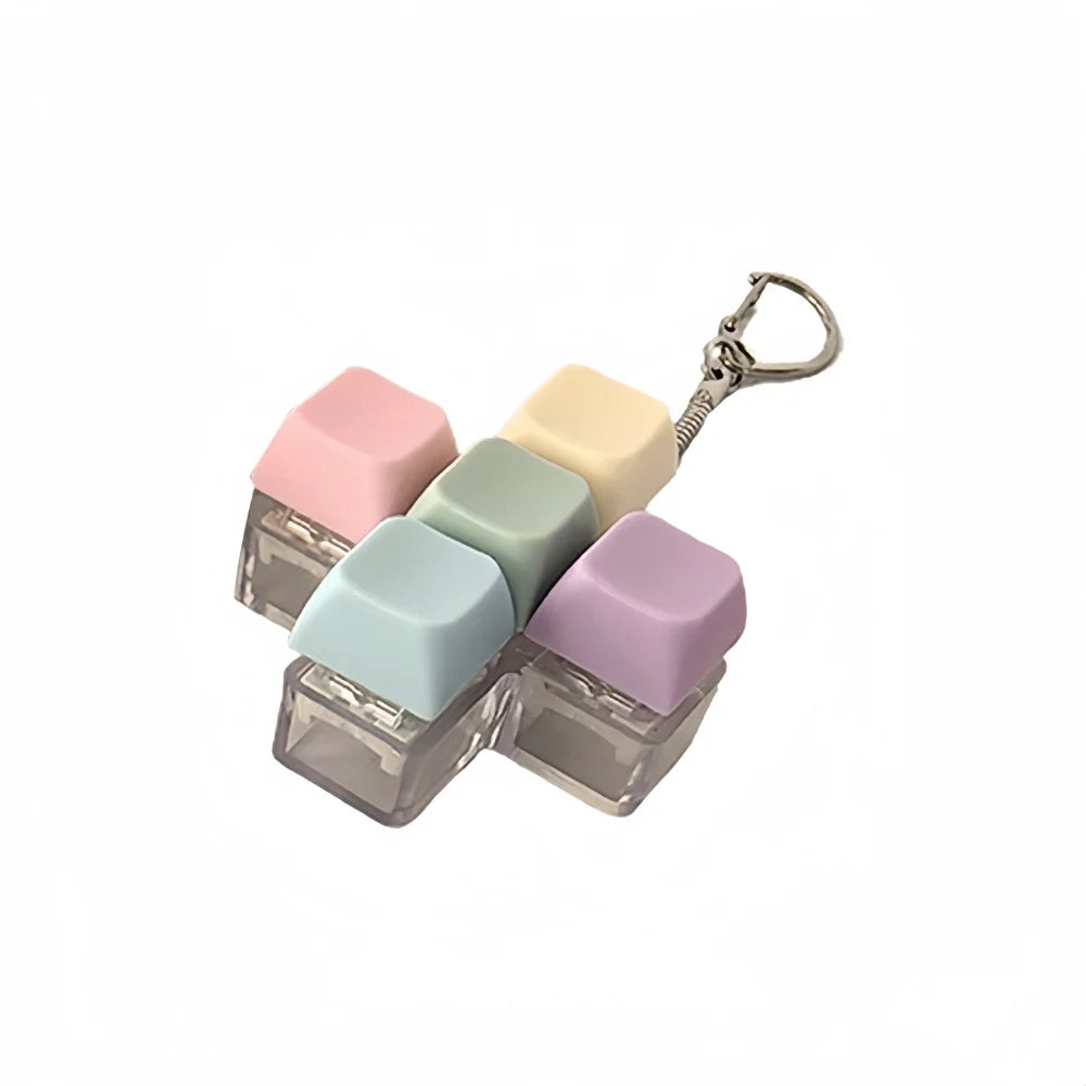A set of five pastel-colored clicking keyboard fidget toys with a metal keychain attached.