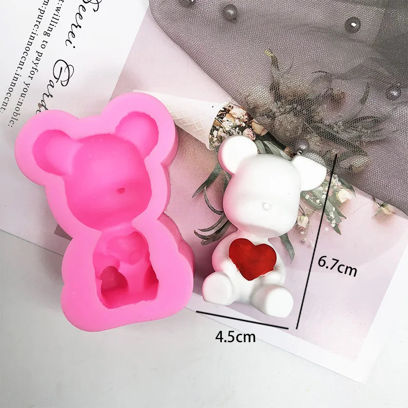 Pink silicone bear hug mold for DIY crafts shown next to a white bear figure and measuring tape.