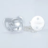 Silver pacifier clip set with a heart-shaped pacifier and a round clip, engraved with the name Tommy