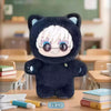 A dark blue plush cat character with white hair and glasses is displayed on a wooden table in a classroom setting.