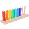 A wooden ring toss game featuring colorful stacking rings in red, orange, yellow, green, and blue, with wooden pegs.