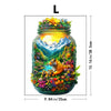 A glass jar filled with a detailed nature scene featuring mountains, trees, flowers, and a tiger head.