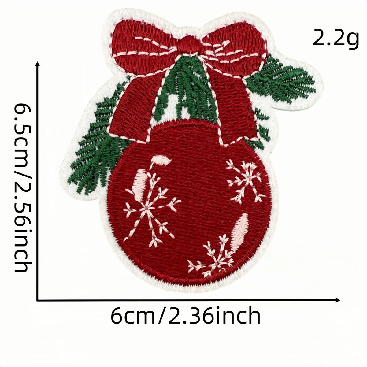 A red festive cartoon character iron-on patch featuring a bow, green foliage, and a large red berry with white snowflake desi
