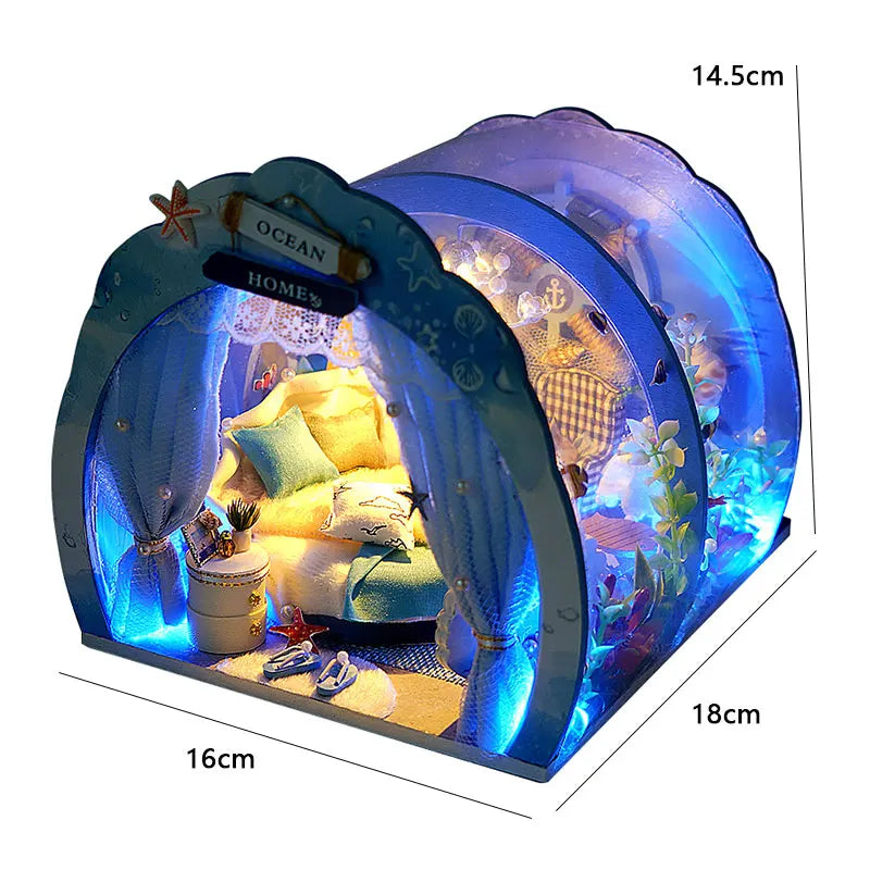 A glowing blue acrylic dollhouse kit depicting a seaside villa interior with furniture.