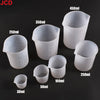 A collection of flexible silicone measuring cups in various sizes including 30ml, 50ml, 100ml, 250ml, 350ml, and 450ml.
