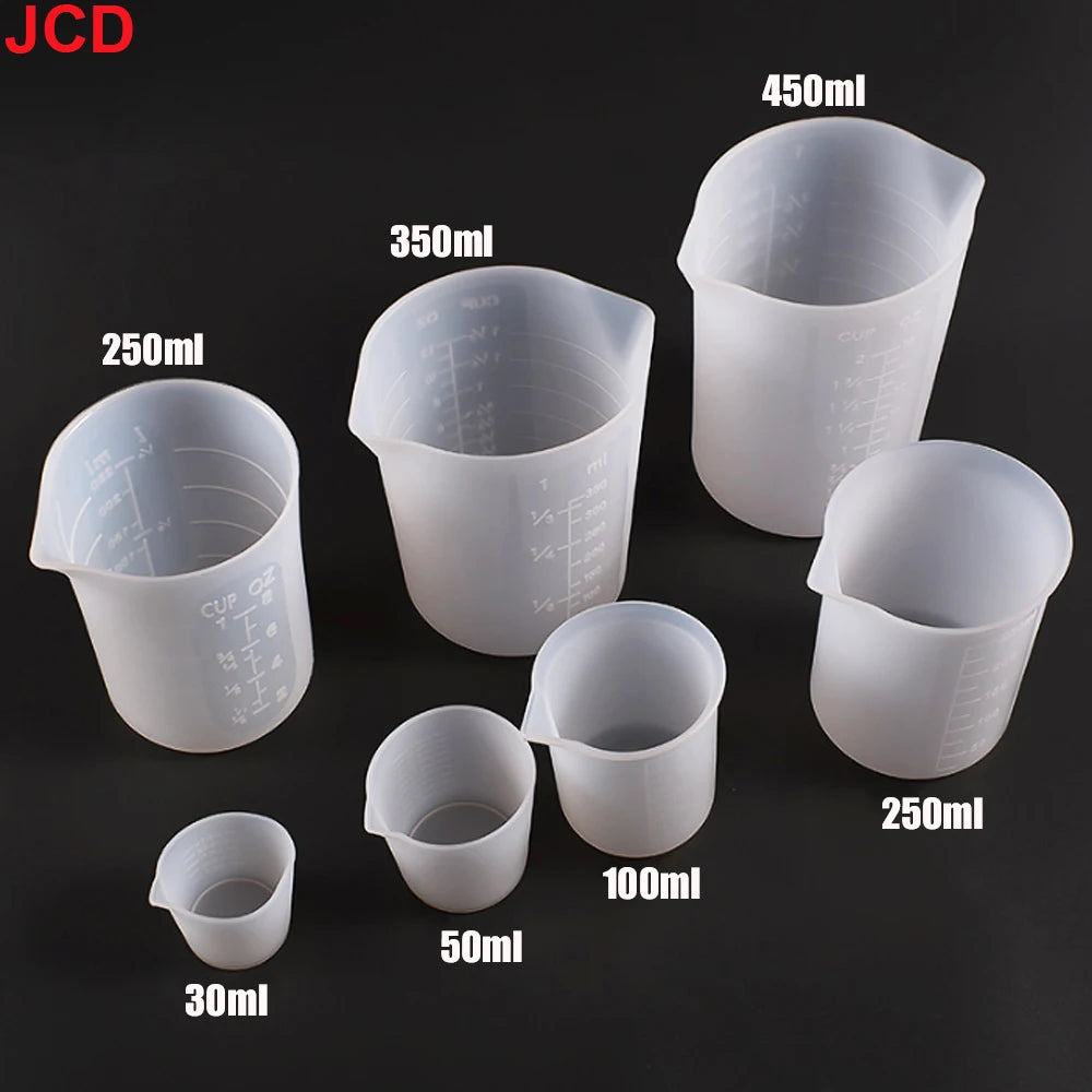 A collection of flexible silicone measuring cups in various sizes including 30ml, 50ml, 100ml, 250ml, 350ml, and 450ml.