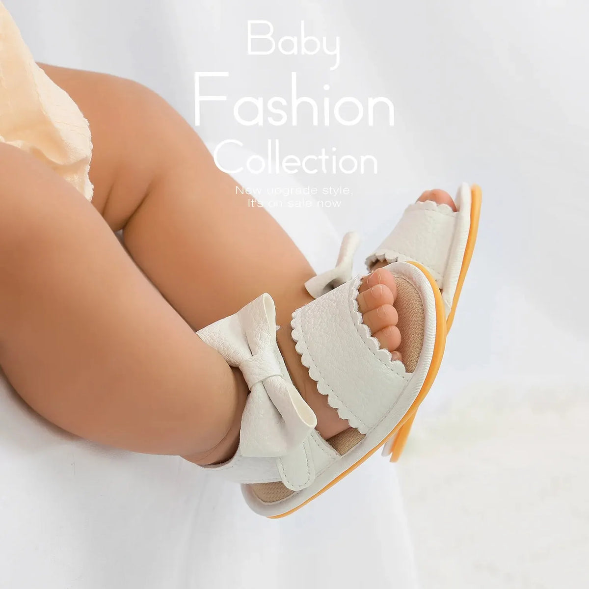 A close-up of a baby's foot wearing light beige summer sandals with a soft anti-slip sole and bowknot detail.