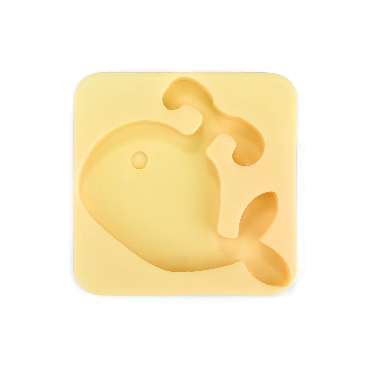 A yellow silicone mold shaped like a fish used for DIY craft kits.