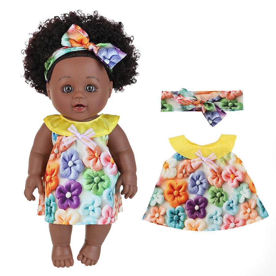 A realistic African American baby doll wearing a floral dress and a bow in her hair.