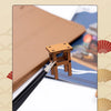 A wooden miniature Japanese restaurant dollhouse kit showing a buckle design and a pencil for guidance.