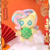 A fluffy, pastel-colored plush pendant featuring a unicorn-like face and a green gemstone, displayed against a white cloud ba