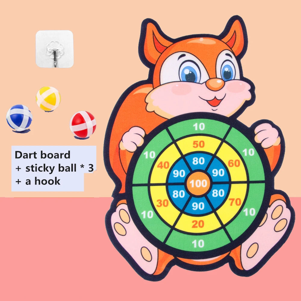 An orange cartoon fox character holding a green dart board with various colored sticky balls and a hook.