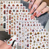 A hand displays vintage angel and saint nail art stickers featuring cherubs, religious figures, and crosses on a nail bed.