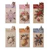 A pack of embossed Christmas advent cards featuring winter themes like snowflakes, wreaths, and holiday decorations.