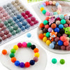A collection of colorful round silicone beads in various shades and sizes for jewelry making and DIY crafts.