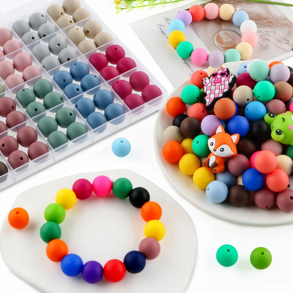 A collection of colorful round silicone beads in various shades and sizes for jewelry making and DIY crafts.