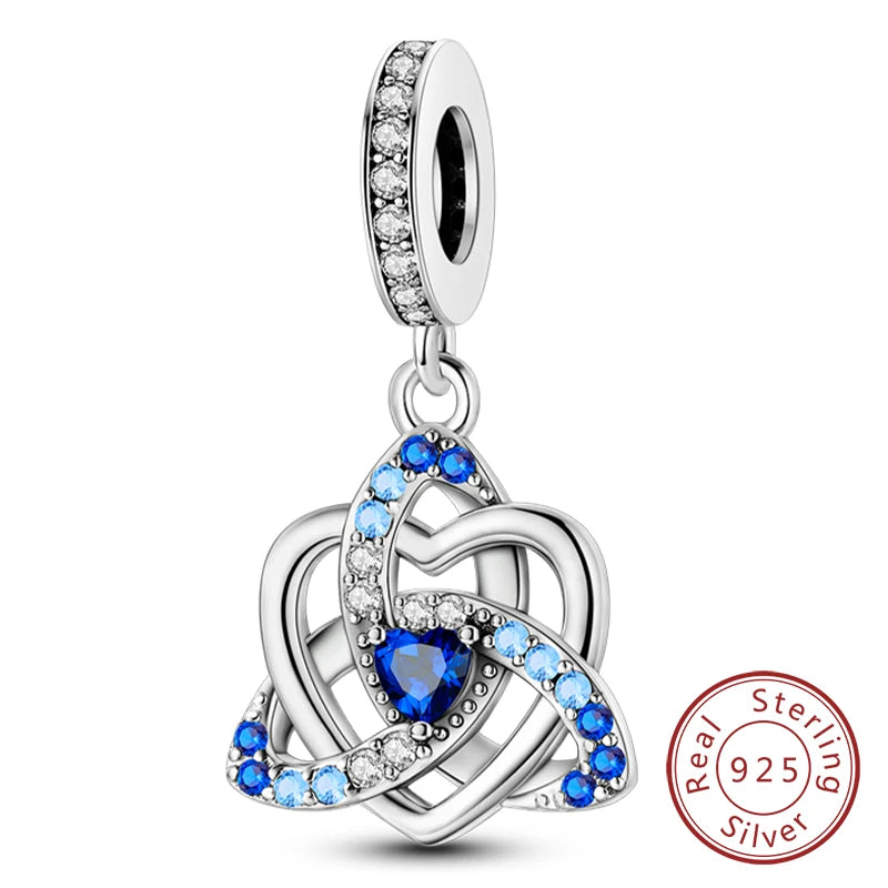 Sterling silver heart charm beads featuring blue sapphires and diamonds forming an intertwined knot design