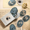 A collection of vintage floral stickers featuring blue, white, and gray flowers on kraft paper.